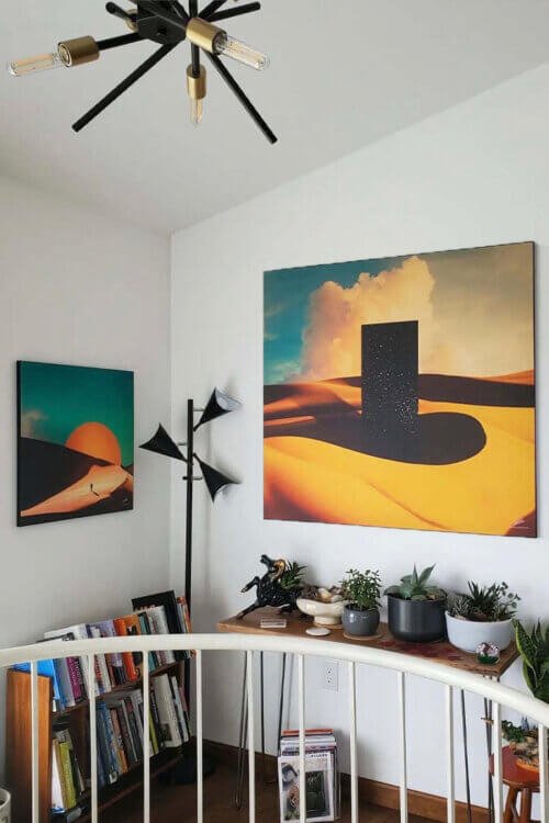 Large desert surreal wall art pairing hangs on white walls in modern office